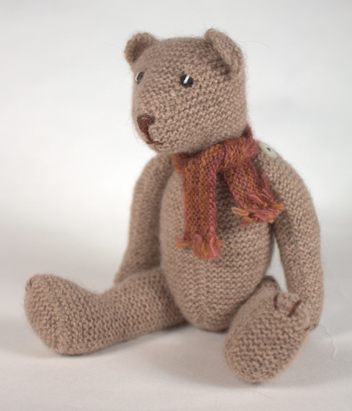 Miniature knitted teddy bear