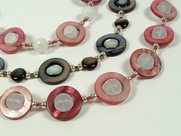 Close-up photo of the trio of UFO shell necklaces.