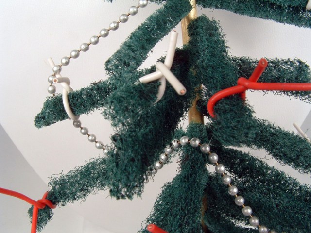 Close-up of ball-chain garland and red/white wire ornaments.
