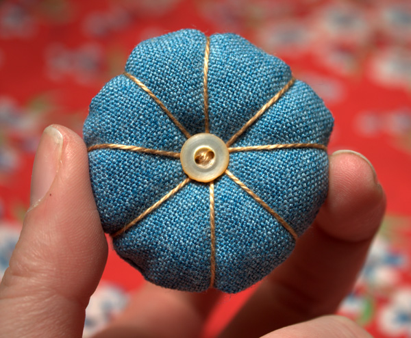 A hand sewn mini pincushion