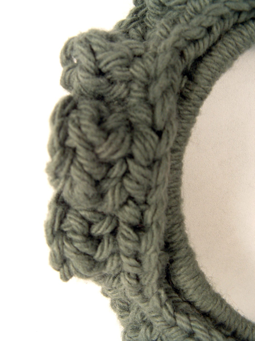 Close up of crochet stitches in wreath ornament.