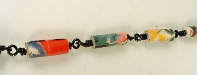 Rolled paper beads wire wrapped to form a necklace chain.
