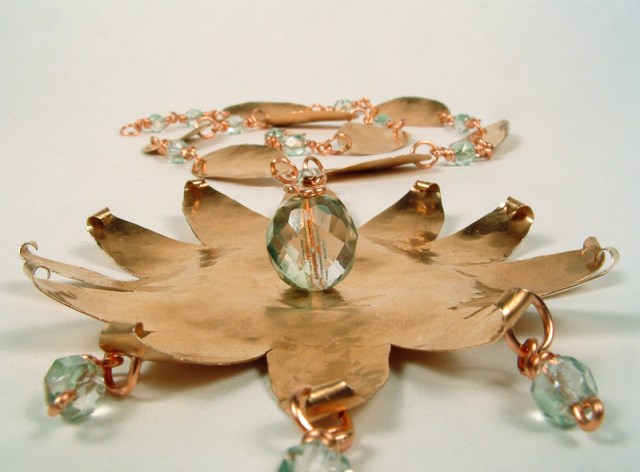 View of copper star-burst necklace from the bottom of the pendant.