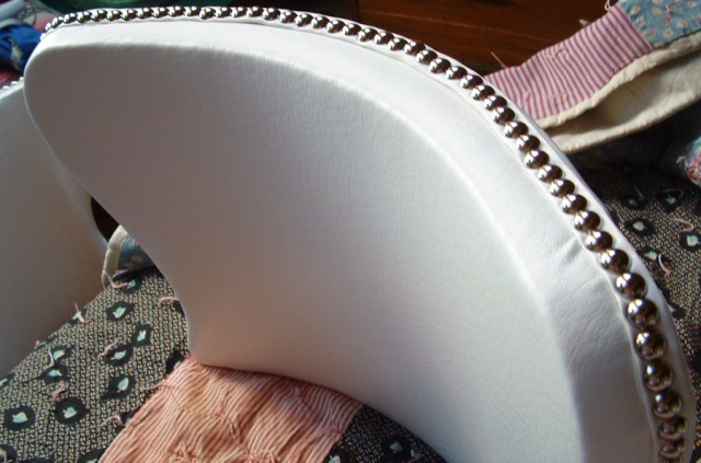 Chair back with new chrome furniture tacks.