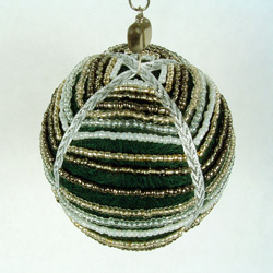 Green thread ball draped with seed beads.