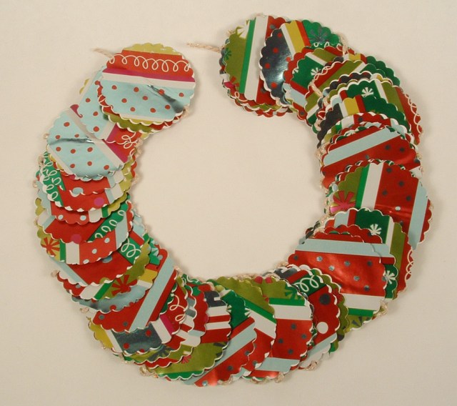 Christmas garland made of Christmas wrap and shaped into a wreath.