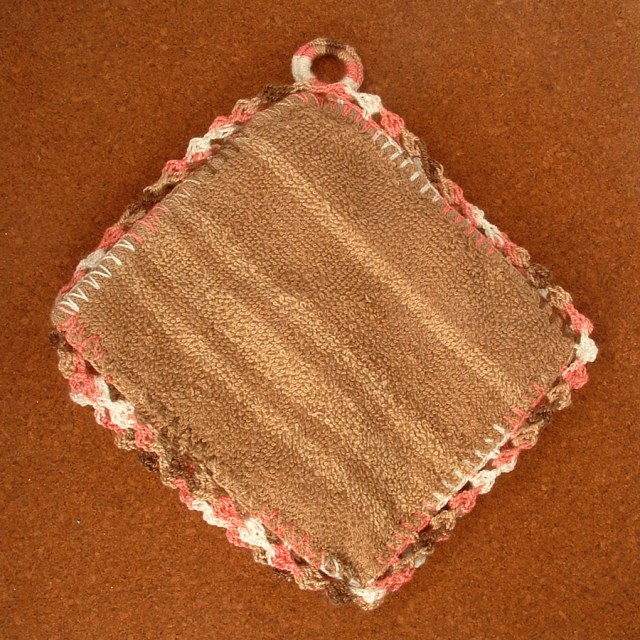 Completed hotpad made from a washcloth and crochet