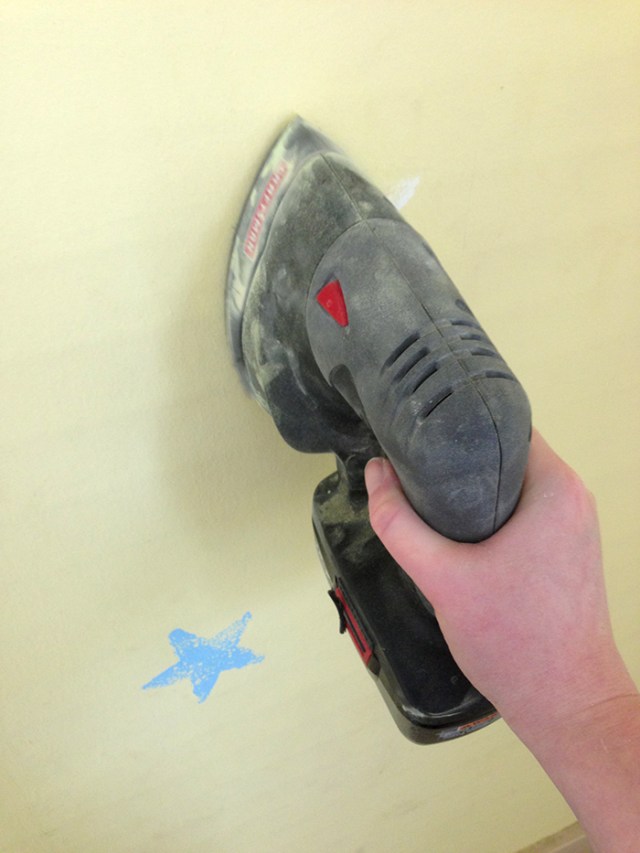 sanding away stenciled designs with a mouse sander