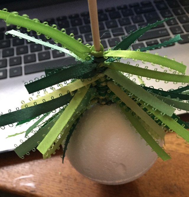 ribbon being tied onto bamboo skewer