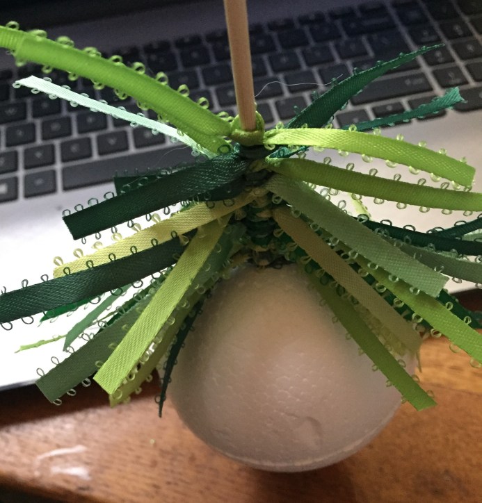ribbon being tied onto bamboo skewer