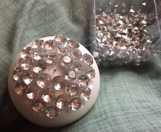 start of gluing rhinestones to foam ball