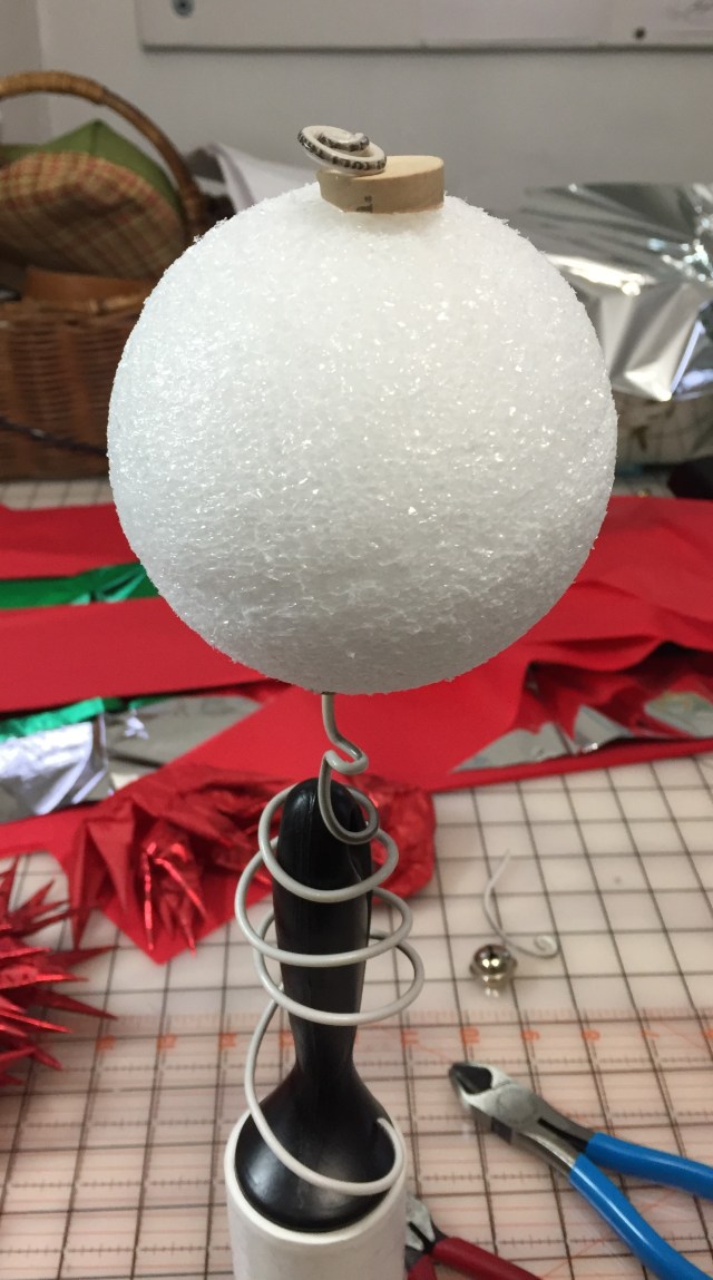 Styrofoam ball with wire stuck threw it.